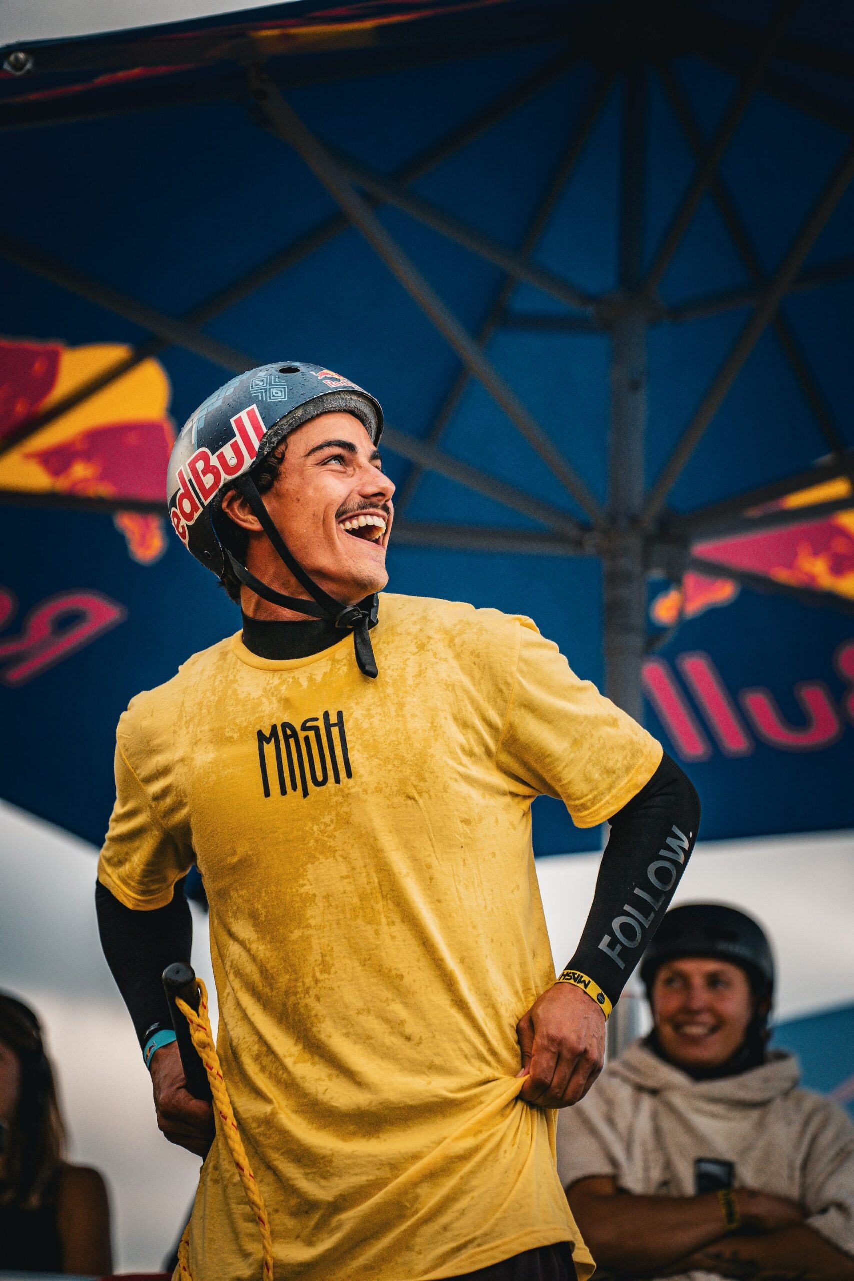 Smiling athlete at Red Bull Munich Mash wearing MASH event shirt.
